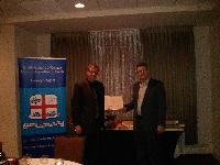 Francis N J Taman presenting Chapter award for highest mark in Canadian Credit Law to Joanne Jenna Foth, Ken Spurr accepting